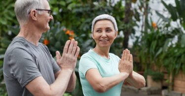 A group of seniors practicing yoga together in a comfortable and safe senior living community setting