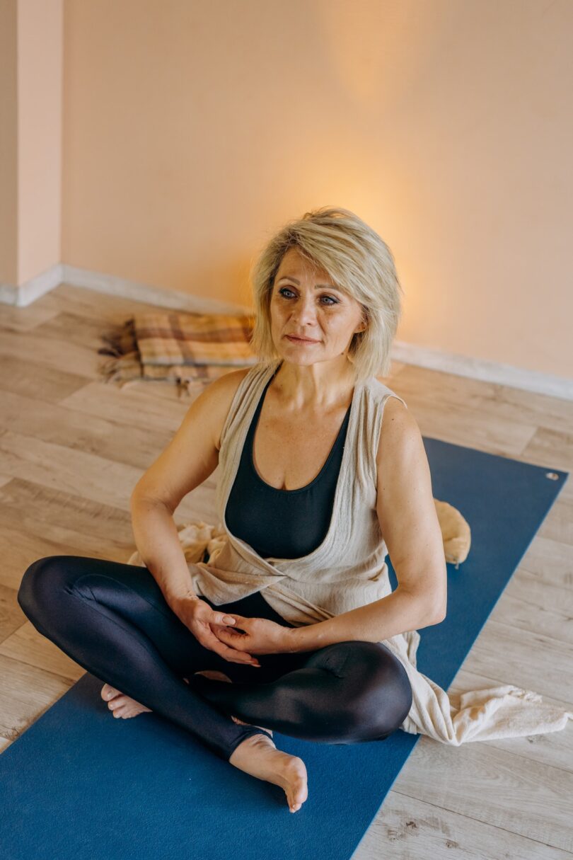 Senior woman practicing yoga in a studio