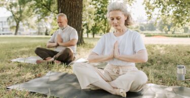 "Group of seniors practicing yoga in a studio designed for their needs"