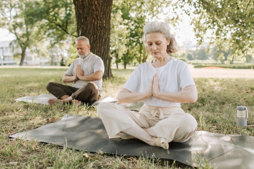 "Group of seniors practicing yoga in a studio designed for their needs"