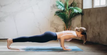 Woman in Black Tank Top and Black Leggings Doing Yoga